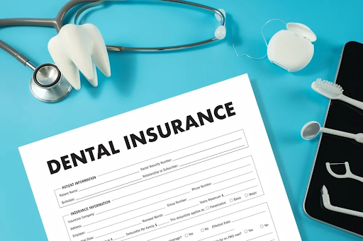 Dental insurance form with toothbrush, floss, and dental tools